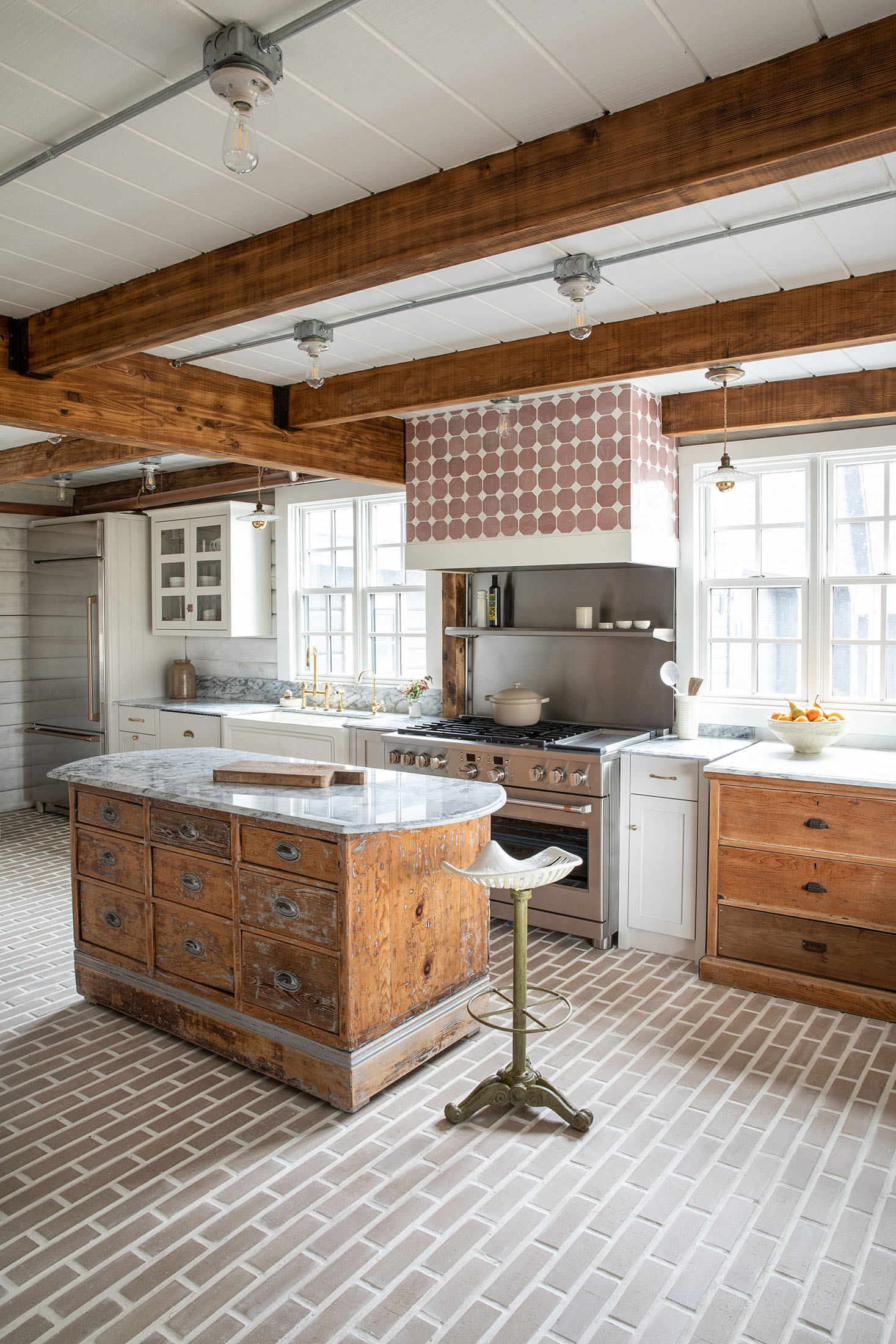 Kitchen with exposed timber beams and divided-lite windows